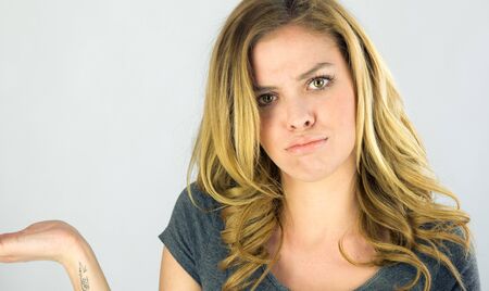 attractive woman on plein background shot in studio with soft lights with an interesting expression and dramatic lightingの写真素材