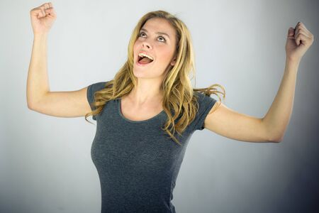 attractive woman on plein background shot in studio with soft lights with an interesting expression and dramatic lightingの写真素材