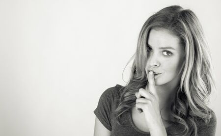 attractive woman on plein background shot in studio with soft lights with an interesting expression and dramatic lighting Black And White, b&wの写真素材