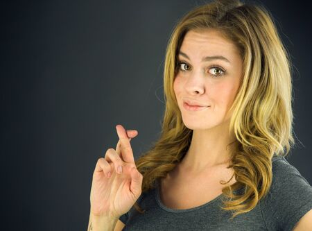 attractive woman on plein background shot in studio with soft lights with an interesting expression and dramatic lightingの写真素材