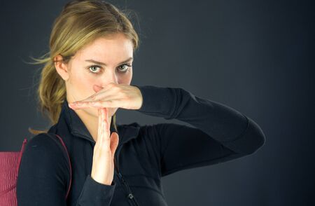 attractive woman on plein background shot in studio with soft lights with an interesting expression and dramatic lightingの写真素材