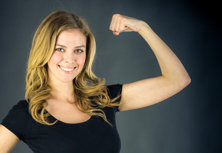 attractive woman on plein background shot in studio with soft lights with an interesting expression and dramatic lightingの写真素材