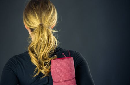 attractive woman on plein background shot in studio with soft lights with an interesting expression and dramatic lightingの写真素材