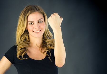 attractive woman on plein background shot in studio with soft lights with an interesting expression and dramatic lightingの写真素材