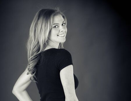 attractive woman on plein background shot in studio with soft lights with an interesting expression and dramatic lighting Black And White, b&wの写真素材