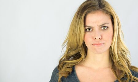 attractive woman on plein background shot in studio with soft lights with an interesting expression and dramatic lightingの写真素材