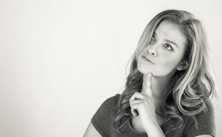 attractive woman on plein background shot in studio with soft lights with an interesting expression and dramatic lighting Black And White, b&wの写真素材