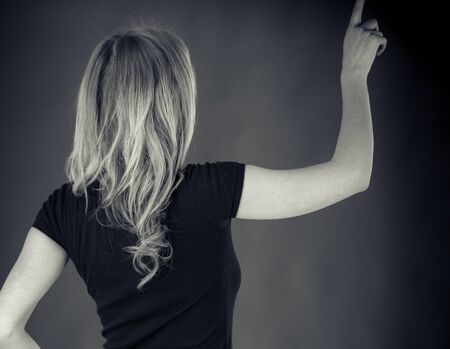 attractive woman on plein background shot in studio with soft lights with an interesting expression and dramatic lighting Black And White, b&wの写真素材