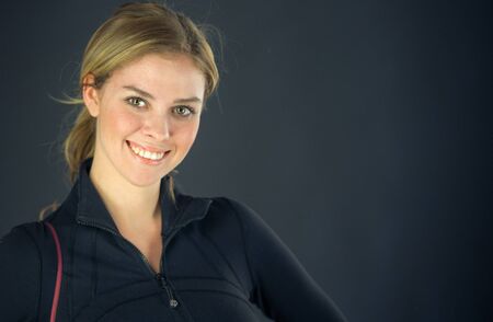 attractive woman on plein background shot in studio with soft lights with an interesting expression and dramatic lightingの写真素材