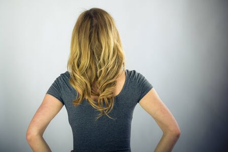 attractive woman on plein background shot in studio with soft lights with an interesting expression and dramatic lightingの写真素材