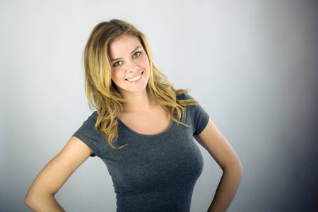 attractive woman on plein background shot in studio with soft lights with an interesting expression and dramatic lightingの写真素材