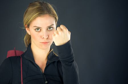 attractive woman on plein background shot in studio with soft lights with an interesting expression and dramatic lightingの写真素材