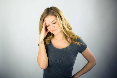 attractive woman on plein background shot in studio with soft lights with an interesting expression and dramatic lightingの写真素材