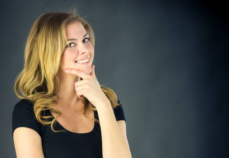 attractive woman on plein background shot in studio with soft lights with an interesting expression and dramatic lightingの写真素材