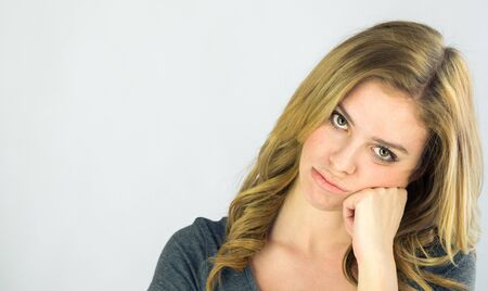 attractive woman on plein background shot in studio with soft lights with an interesting expression and dramatic lightingの写真素材