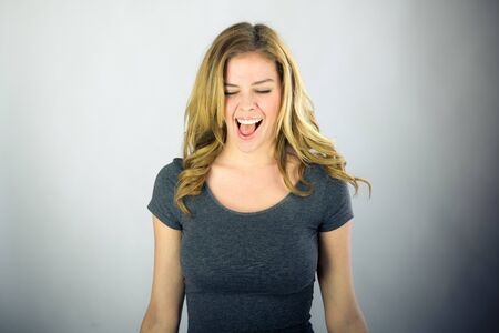 attractive woman on plein background shot in studio with soft lights with an interesting expression and dramatic lightingの写真素材