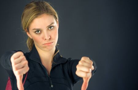 attractive woman on plein background shot in studio with soft lights with an interesting expression and dramatic lightingの写真素材