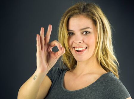 attractive woman on plein background shot in studio with soft lights with an interesting expression and dramatic lightingの写真素材