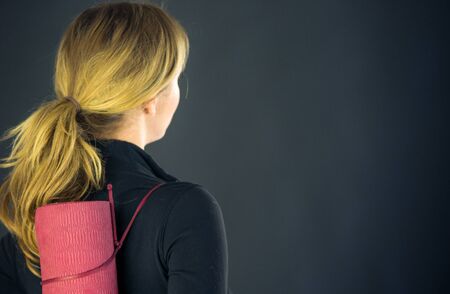 attractive woman on plein background shot in studio with soft lights with an interesting expression and dramatic lightingの写真素材