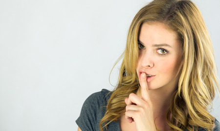attractive woman on plein background shot in studio with soft lights with an interesting expression and dramatic lightingの写真素材
