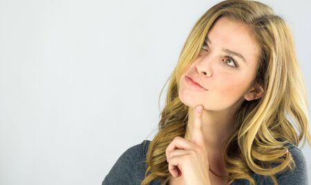 attractive woman on plein background shot in studio with soft lights with an interesting expression and dramatic lightingの写真素材