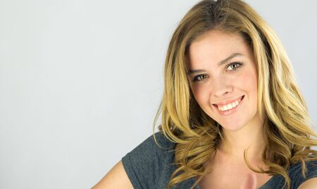 attractive woman on plein background shot in studio with soft lights with an interesting expression and dramatic lightingの写真素材