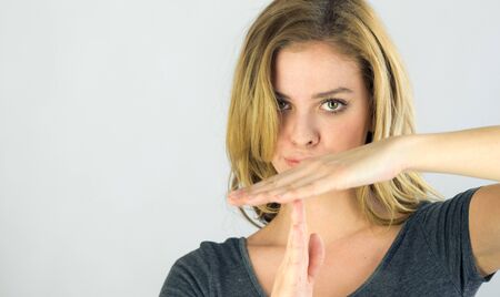 attractive woman on plein background shot in studio with soft lights with an interesting expression and dramatic lightingの写真素材