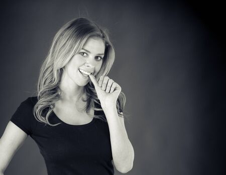 attractive woman on plein background shot in studio with soft lights with an interesting expression and dramatic lighting Black And White, b&wの写真素材
