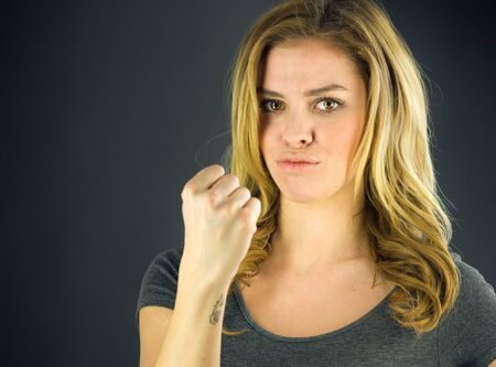 attractive woman on plein background shot in studio with soft lights with an interesting expression and dramatic lightingの写真素材