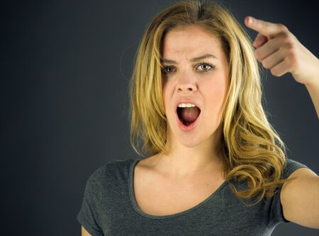 attractive woman on plein background shot in studio with soft lights with an interesting expression and dramatic lightingの写真素材