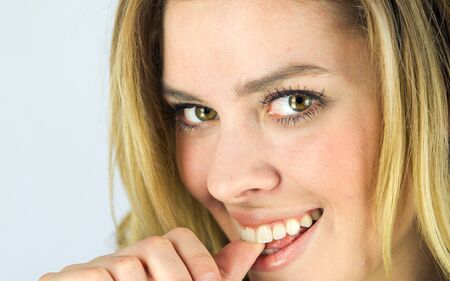 attractive woman on plein background shot in studio with soft lights with an interesting expression and dramatic lightingの写真素材