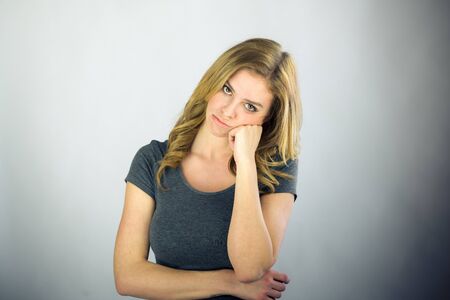 attractive woman on plein background shot in studio with soft lights with an interesting expression and dramatic lightingの写真素材