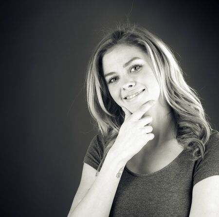 attractive woman on plein background shot in studio with soft lights with an interesting expression and dramatic lighting Black And White, b&wの写真素材