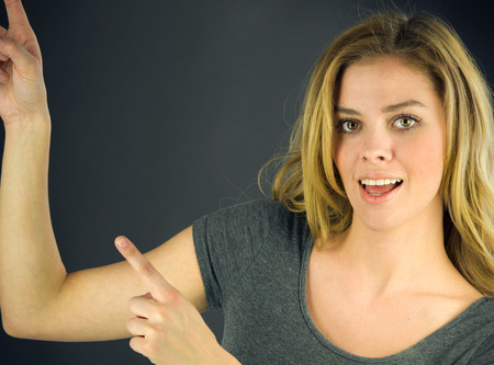 attractive woman on plein background shot in studio with soft lights with an interesting expression and dramatic lightingの写真素材