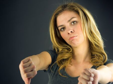 attractive woman on plein background shot in studio with soft lights with an interesting expression and dramatic lightingの写真素材