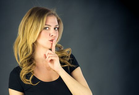 attractive woman on plein background shot in studio with soft lights with an interesting expression and dramatic lightingの写真素材