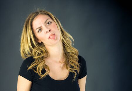 attractive woman on plein background shot in studio with soft lights with an interesting expression and dramatic lightingの写真素材