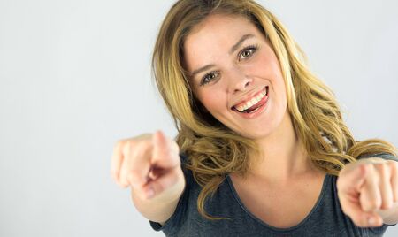 attractive woman on plein background shot in studio with soft lights with an interesting expression and dramatic lightingの写真素材
