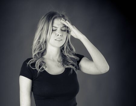 attractive woman on plein background shot in studio with soft lights with an interesting expression and dramatic lighting Black And White, b&wの写真素材