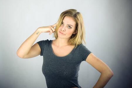attractive woman on plein background shot in studio with soft lights with an interesting expression and dramatic lightingの写真素材
