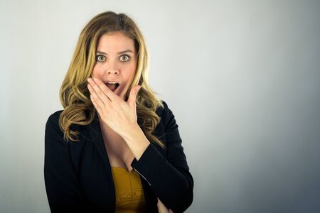 attractive woman on plein background shot in studio with soft lights with an interesting expression...