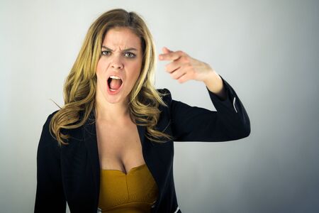 attractive woman on plein background shot in studio with soft lights with an interesting expression and dramatic lightingの写真素材