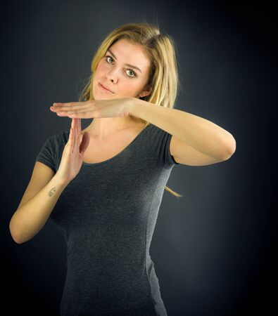 attractive woman on plein background shot in studio with soft lights with an interesting expression and dramatic lightingの写真素材