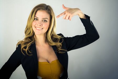attractive woman on plein background shot in studio with soft lights with an interesting expression and dramatic lightingの写真素材