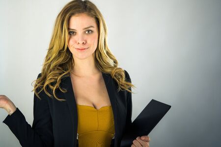 attractive woman on plein background shot in studio with soft lights with an interesting expression and dramatic lightingの写真素材
