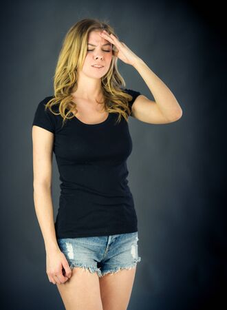 attractive woman on plein background shot in studio with soft lights with an interesting expression and dramatic lightingの写真素材