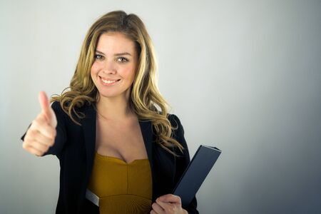 attractive woman on plein background shot in studio with soft lights with an interesting expression and dramatic lightingの写真素材