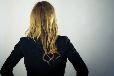 attractive woman on plein background shot in studio with soft lights with an interesting expression and dramatic lightingの写真素材