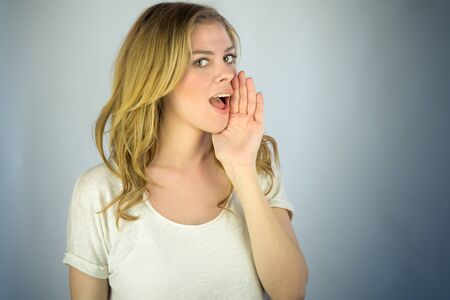 attractive woman on plein background shot in studio with soft lights with an interesting expression...