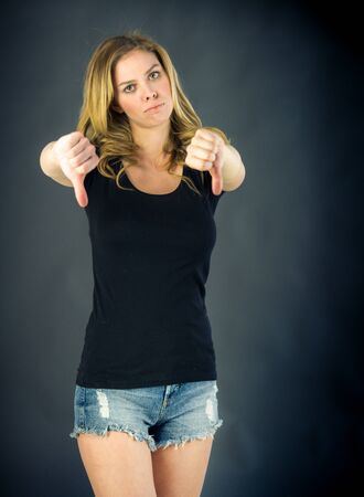 attractive woman on plein background shot in studio with soft lights with an interesting expression and dramatic lightingの写真素材